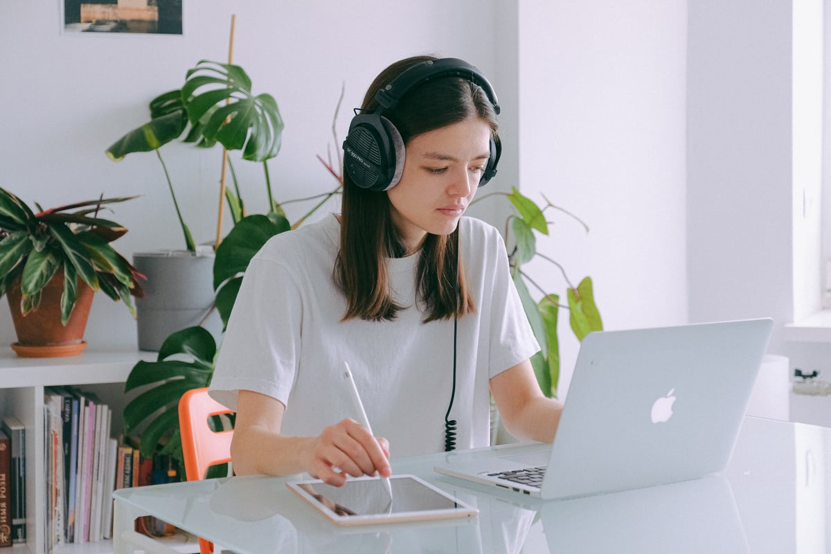 Woman In White Shirt Using Silver Macbook